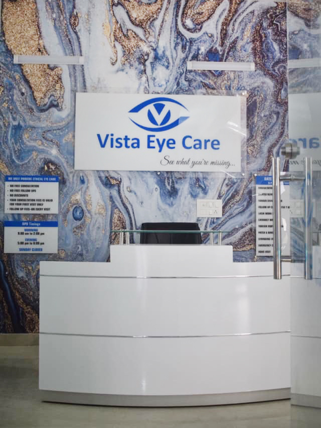 Reception desk under the main Vista Eye Care logo sign