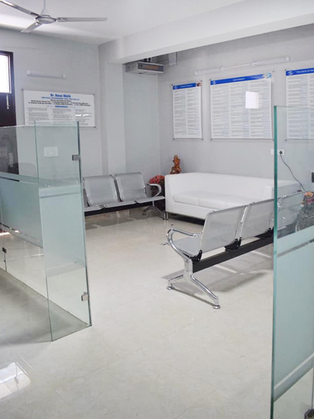 Patient waiting area with bench seating and certificates on the wall