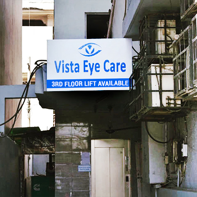 Street-level entrance signboard for Vista Eye Care